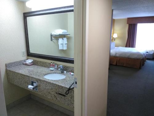a bathroom with a sink in a hotel room at Baymont by Wyndham Clinton in Clinton