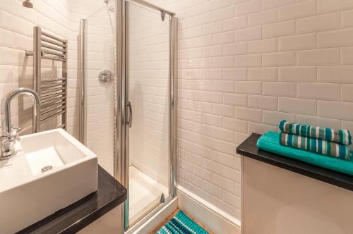 een badkamer met een wastafel en een douche bij Elm Lodge in Plymouth