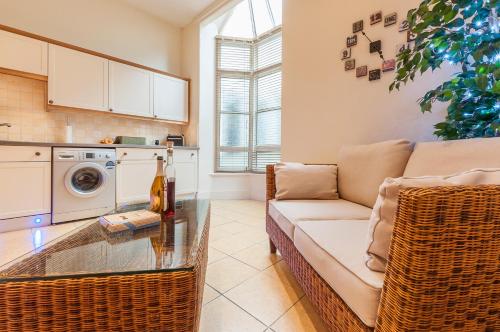 a living room with a couch and a table at Elm Lodge in Plymouth