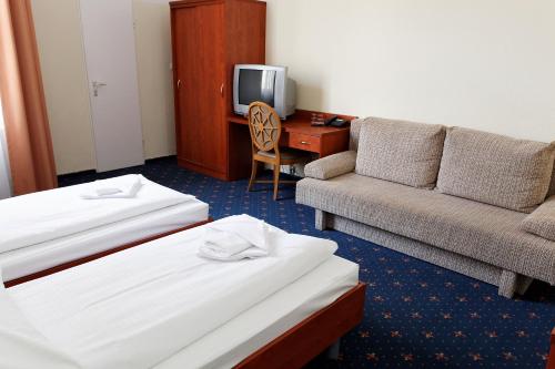 En eller flere senge i et værelse på Hotel Europa City