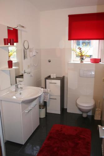 a bathroom with a white sink and a toilet at Haus Gezeiten in Meldorf