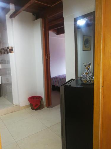 a room with a mirror and a dresser and a bedroom at El Hostal By Pochet in San Andrés