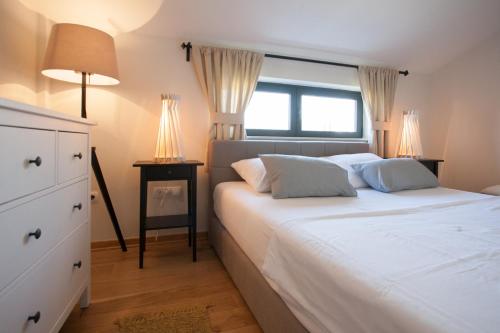 a bedroom with a large white bed with two lamps at Bella Vista Suites in Vis