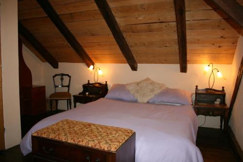 a bedroom with a large bed with wooden ceilings at Villa Rustica in Hruškovica