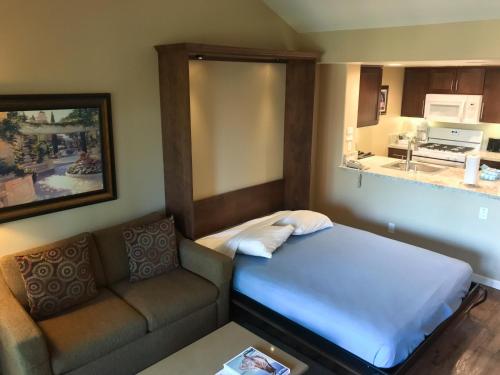 a small room with a couch and a bed at The Oasis Resort in Palm Springs