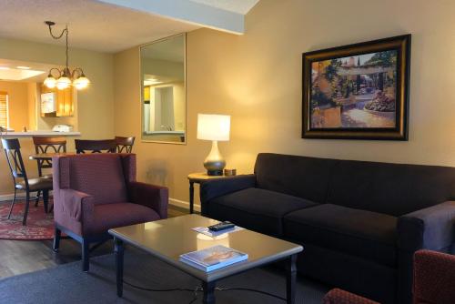 a living room with a couch and chairs and a table at The Oasis Resort in Palm Springs