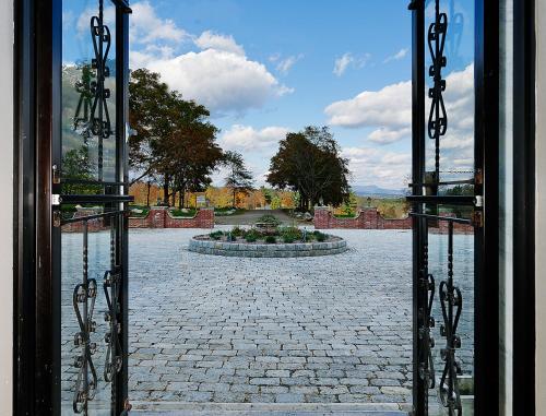 an open door to a courtyard with a fountain at Eastover Estate and Eco Village in Lenox