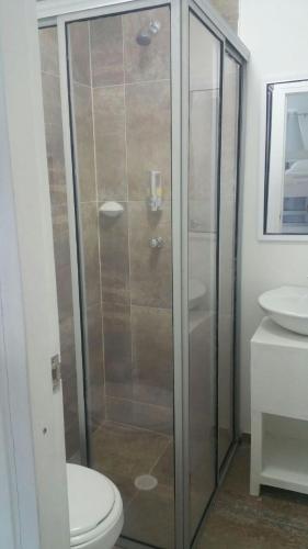 a bathroom with a shower with a toilet and a sink at Sashii Hostel & Boutique. in Ríohacha