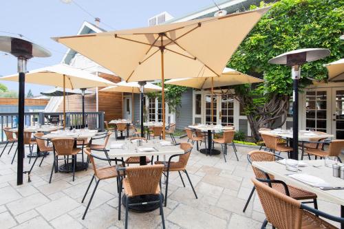 an outdoor patio with tables and chairs and umbrellas at El Dorado Hotel in Sonoma