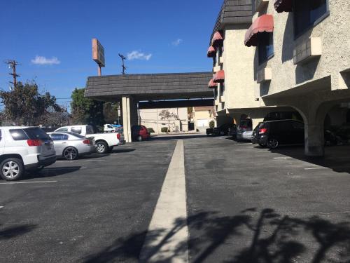 a parking lot with cars parked next to a building at Grand Inn財神客棧 in Monterey Park