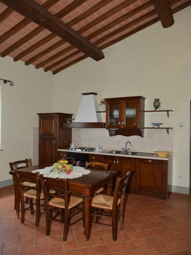 a kitchen with a table and chairs and a sink at Agriturismo Musignano in Cerreto Guidi