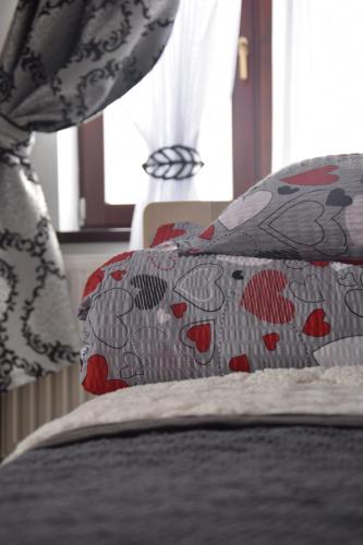 a close up of a bed with pillows on it at Apartamenty u Klisia in Ząb