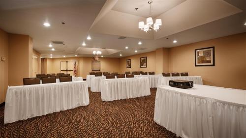 a conference room with white tables and chairs at Best Western Palm Court Inn in Modesto