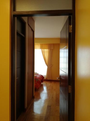 an open door to a room with a window at The Oruro Inn in Oruro
