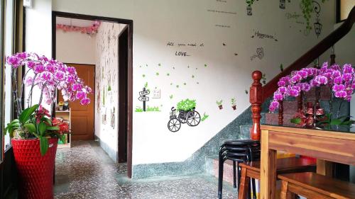 a hallway with purple flowers on the wall at Zhongshan Hostel in Fenchihu
