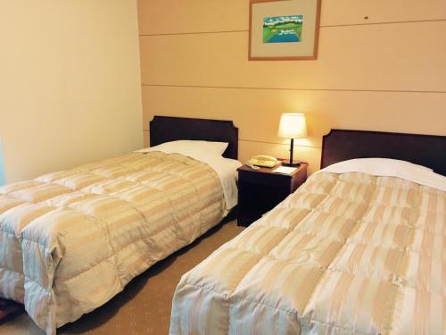 Postel nebo postele na pokoji v ubytování Ohito Hotel