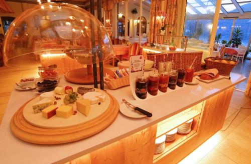 a buffet with a plate of food on a counter at Hotel Glocknerhof in Berg im Drautal