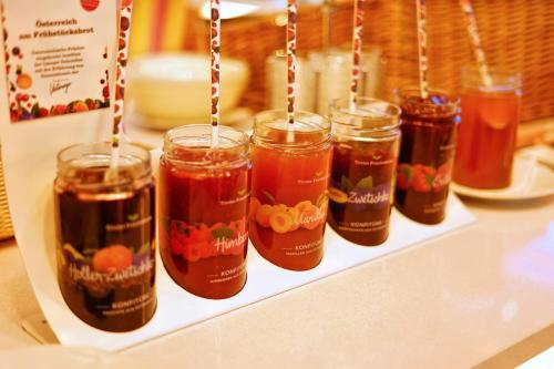 a group of jars of jam on a shelf at Hotel Glocknerhof in Berg im Drautal
