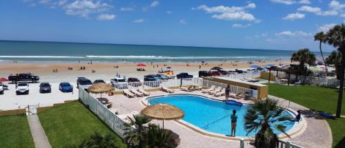a view of a beach with a swimming pool and the ocean at Driftwood Beach Motel in Ormond Beach