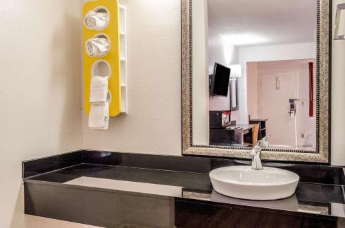 a bathroom with a sink and a mirror at Motel 6-Saraland, AL in Saraland