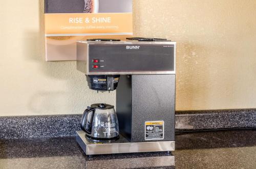a coffee machine with a tea kettle in a hotel room at Motel 6-Saraland, AL in Saraland