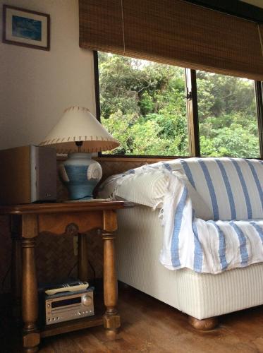a table with a lamp on it next to a window at Mayagusuku Resort in Iriomote