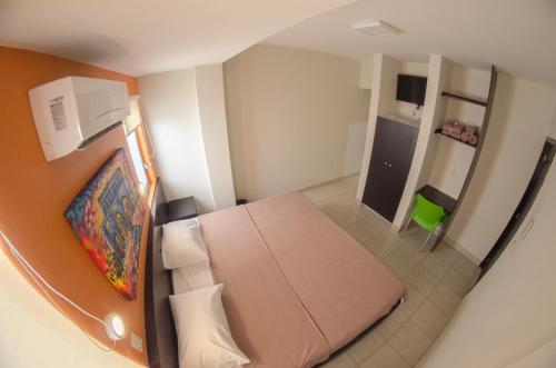 an overhead view of a bedroom with a bed and a kitchen at Hotel Belisario INN in Guadalajara