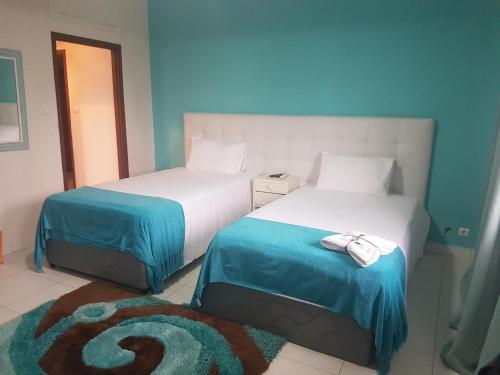 Un pat sau paturi într-o cameră la Orquidea GuestHouse Spa & Restaurant