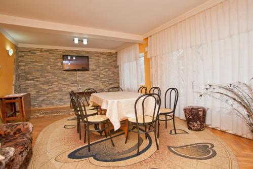 a dining room with a table and chairs at Casa Tudor in Sinaia