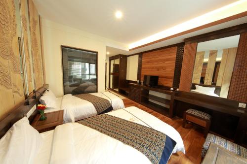 מיטה או מיטות בחדר ב-The Home Hotel