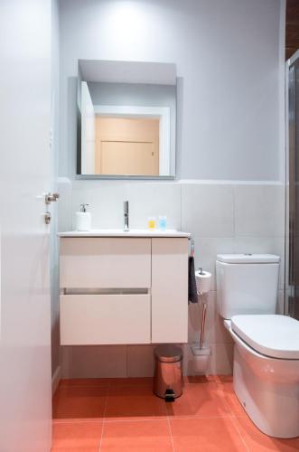a bathroom with a white sink and a toilet at Hotel Fira Boutique Barcelona in Hospitalet de Llobregat