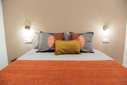 um quarto com uma cama com almofadas coloridas em Fira Basic em L'Hospitalet de Llobregat