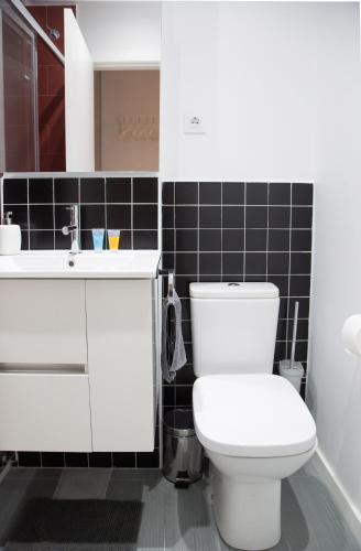 a bathroom with a white toilet and a sink at Hotel Fira Boutique Barcelona in Hospitalet de Llobregat