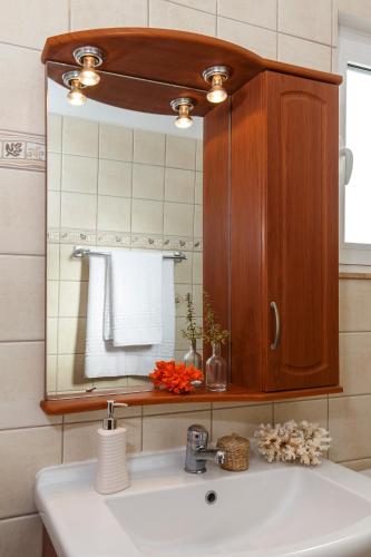 a bathroom with a sink and a mirror at Summer Breeze Villa in Afantou