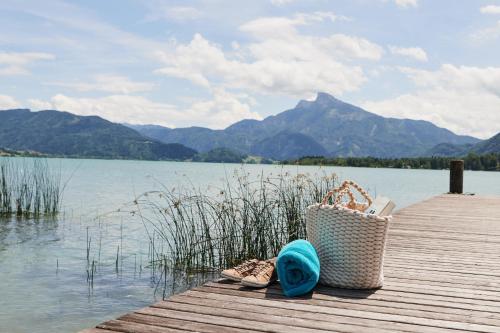 a pair of shoes and a basket on a dock at Seehotel Restaurant Lackner in Mondsee