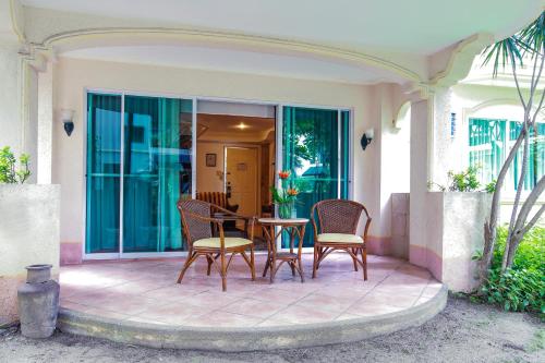 a patio with chairs and a table on a house at Paradise Garden Hotel and Convention Center Boracay Powered by ASTON in Boracay