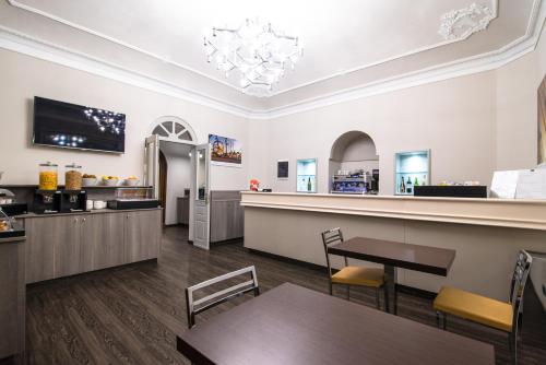a restaurant with a table and chairs and a counter at Hotel Astoria in Turin