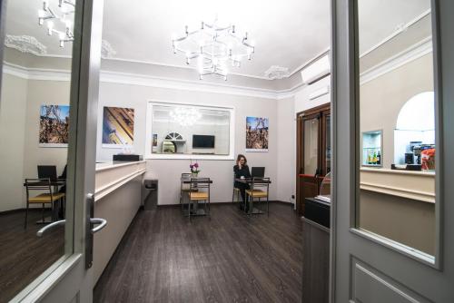 a woman sitting at a desk in an office at Hotel Astoria in Turin