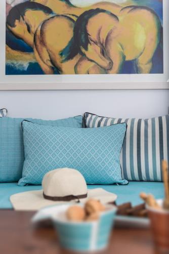 a couch with a painting of horses on it at Elements of Caldera Suites in Akrotiri