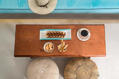 a table with a cup of coffee and food on it at Elements of Caldera Suites in Akrotiri
