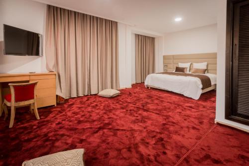 מיטה או מיטות בחדר ב-Hôtel Mansour