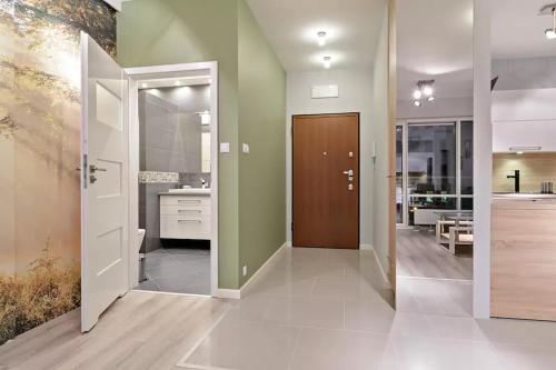 a bathroom with green walls and a brown door at Strict center Towarowa in Poznań