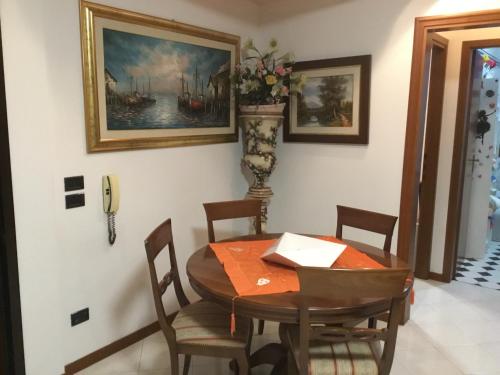 a dining room with a wooden table and chairs at La Stellina in Castenaso