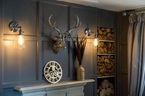 a room with a table with antlers on the wall at Greyhound Inn Wilton in Salisbury