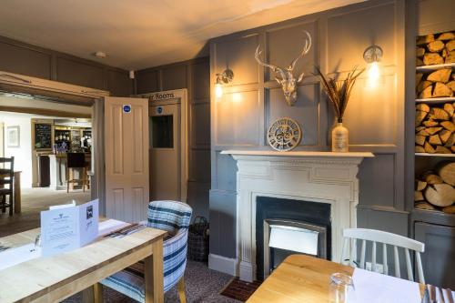 a living room filled with furniture and a fireplace at Greyhound Inn Wilton in Salisbury