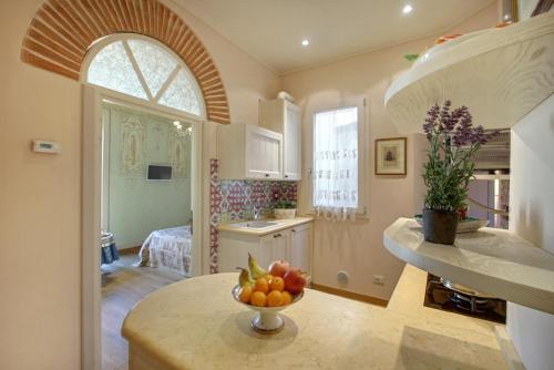 a kitchen with a bowl of fruit on a table at Romantic apartment in the heart of Florence in Florence