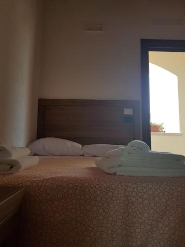 Ένα ή περισσότερα κρεβάτια σε δωμάτιο στο Agriturismo L'Ulivo