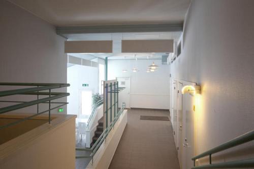 a hallway in an office building with a hallway at Hotel Himos in Jämsä