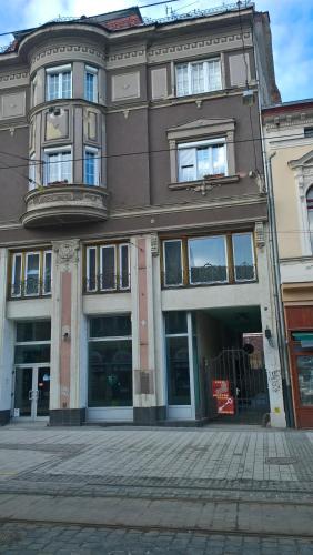 a large building with many windows on a street at Széchenyi Apartman Miskolc belvárosban in Miskolc