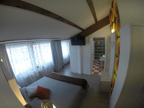 a bedroom with a bed and a large window at B&B Seventy Design in Dimaro